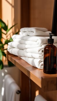 Spa treatment set, wooden shelf with neatly folded towels and dispensers for soap, cream, massage oil. High quality photo