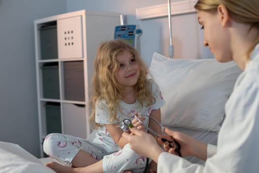 In a warm and caring hospital environment, a compassionate medical professional checks the health of a smiling child