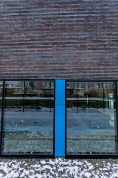 Sleek building exterior showcasing a blend of glass and brick, ideal for contemporary design themes.