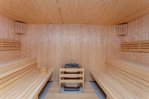 The interior of a calm and peaceful wooden sauna offers an ideal setting for deep relaxation and health rejuvenation