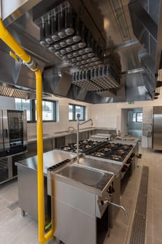 This is a spacious, welldesigned commercial kitchen that features advanced stainless steel appliances and equipment