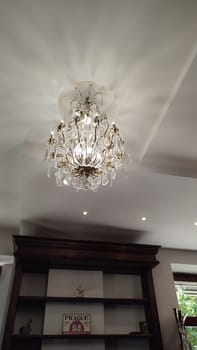 October 15 2024 Prague Czech Republic Europe Chandelier ceiling bookshelf hotel lamp interior . High quality photo