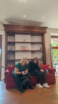 October 15 2024 Prague Czech Republic Europe People sitting sofa womens tourist friendly hotel apartment room . High quality photo