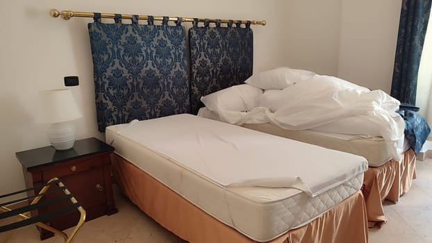 Unmade bed pillows room apartment hotel interior design decor indoor house wall travel tourism objects . High quality photo