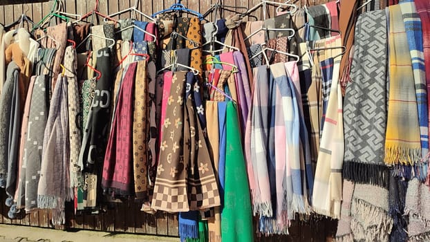 Scarves hanging display clothing shop sale shopping centre culture colour . High quality photo