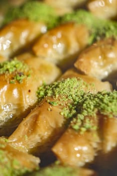 Freshly made pastry with nut filling and sweet syrup, garnished with green.