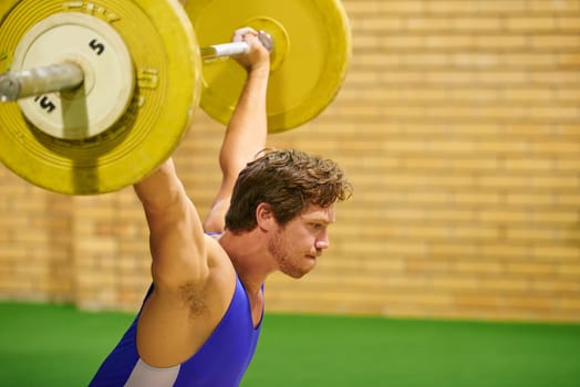 A weight lifter lifting weights during a competition