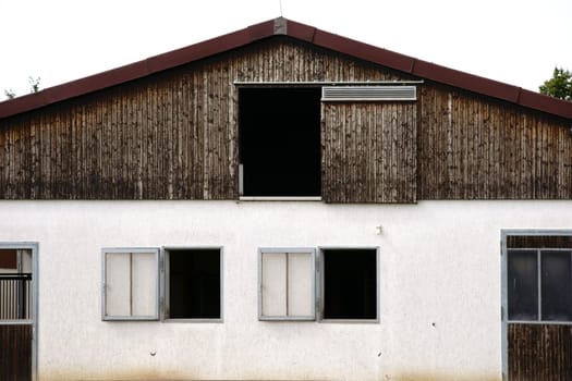 The exterior façade of the stables of a riding stable.