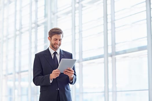 Corporate executive using a digital tablet in a modern architectural setting