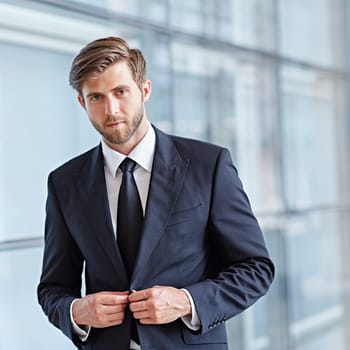 Portrait of a stylish corporate executive looking seriously at the camera