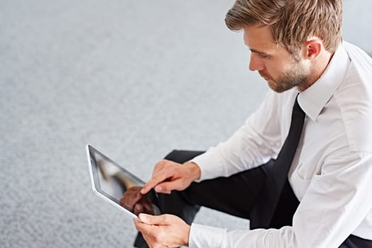 High angle view of a businessman using a digital tablet