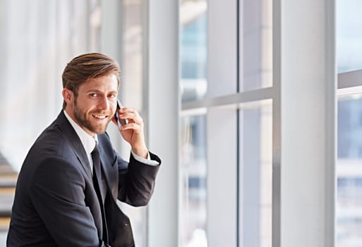 Portrait of a corporate executive smiling while talking on his phone