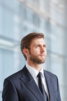 Portrait of a corporate executive looking up thoughtfully and confidently