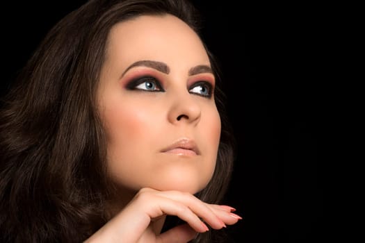 Beauty portrait about woman with blue eyes and light pink make-up.