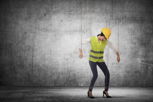Asian business woman hace string attached on her body like marionette. Business manipulated concept