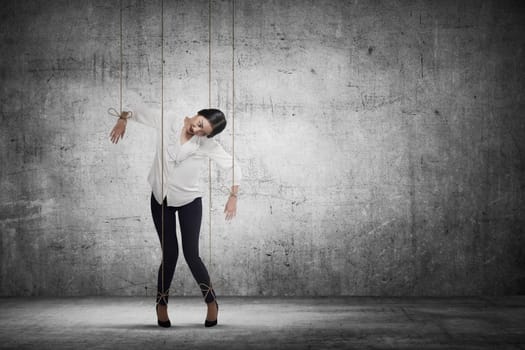 Asian business woman hace string attached on her body like marionette. Business manipulated concept