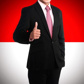Business man show thumb up with indonesian banner background
