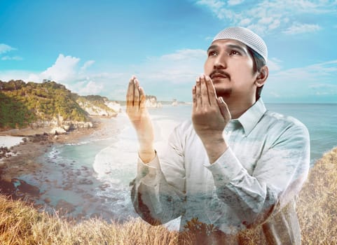 Image of multi exposure man praying with beach background