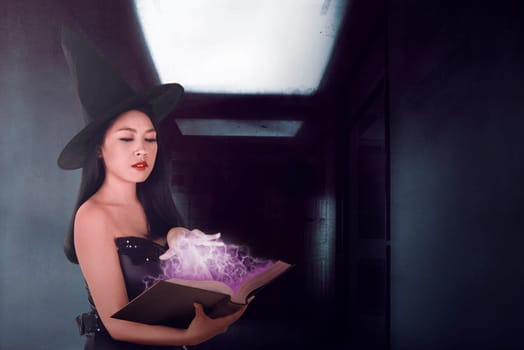 Sexy witch woman spell with the book in the dark room, halloween art design