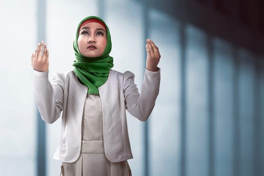 Image of muslim woman praying over mosque background