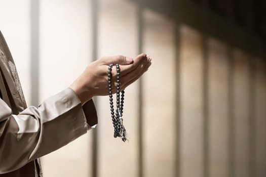 Hand of muslim people praying with mosque interior background