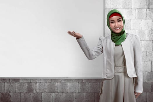 Image of muslim business woman show something