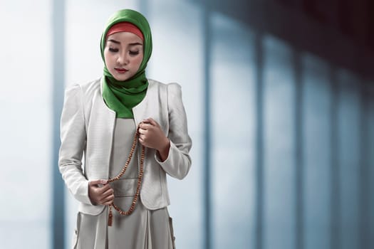 Muslim woman holding prayer beads inside the mosque