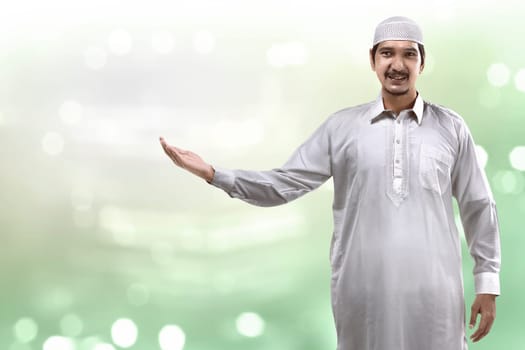 Image of muslim handsome man show something