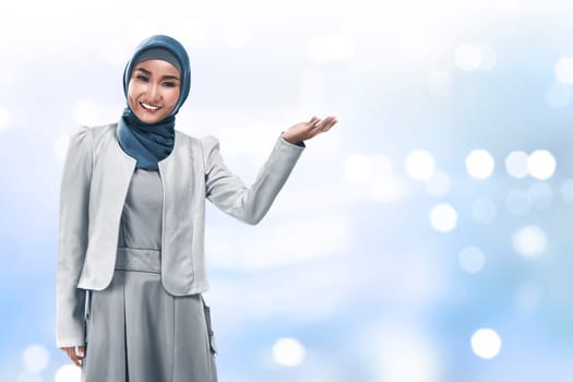Image of muslim business woman show something