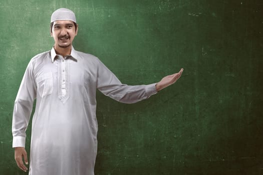 Image of muslim handsome man show something