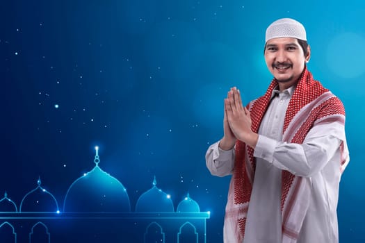 Young asian muslim man wearing cap and neat dress and mosque logo background. You can put your design to make giftcards