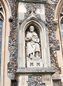 statue of man on the outside of english christian church made of stone Essex  England  UK