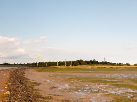 mud flat texture of earth landscape Maldon black water road leading onto island tide out Essex  England  UK