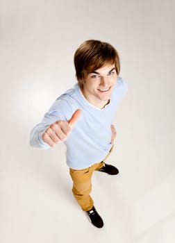 Portrait of a handsome young man looking up and laughing