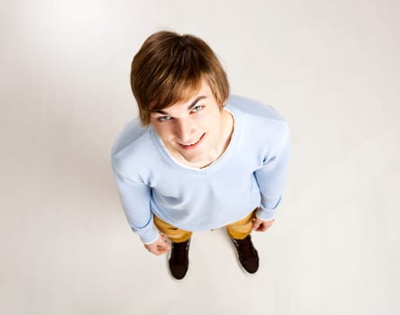 Portrait of a handsome young man looking up and laughing