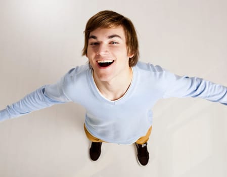 Portrait of a handsome young man looking up and laughing
