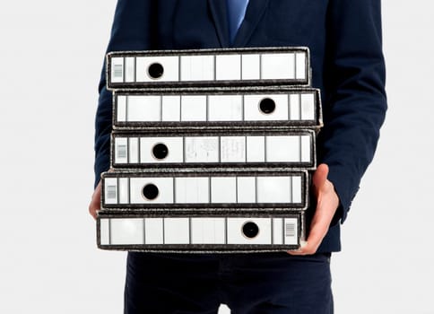 Young business man carrying a bunch of folders