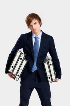 Young business man carrying a bunch of folders