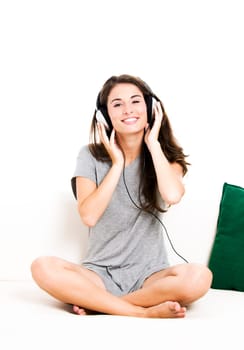 Beautiful woman listen music at home, isolated in white