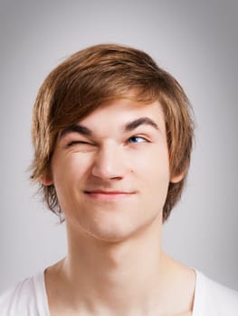 Portrait of a handsome young man looking up and laughing