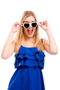 Beautiful woman in blue dress using sunglasses with a hearth shape, isolated over white background