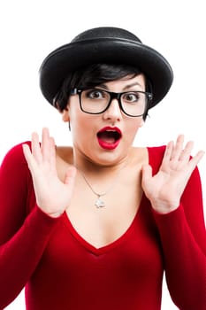 Beautiful nerd girl wearing a santa hat and holding a gift, against yellow background
