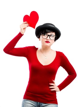 Beautiful nerd girl wearing a santa hat and holding a gift, against yellow background