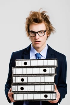 Young business man carrying a bunch of folders