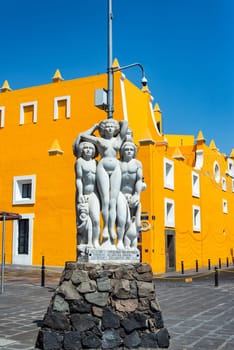 PUEBLA, MEXICO - MARCH 2: Statue and yellow theater in the Artist Quarter in Puebla, Mexico on March 2, 2017