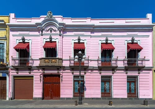 Facade of a beautiful pink colonial building in Puebla, Mexico