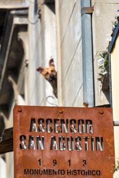 Sign for the San Agustin Ascensor in Valparaiso, Chile with a dog in the background