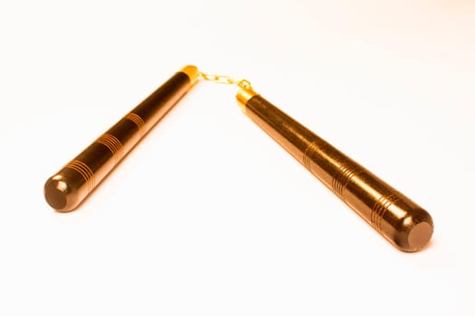 Bronze nunchaku, the Asian weapon is isolated on white background.