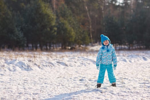 Full length shot of an adorable little girl standing in a snowy park on a sunny winter's day
