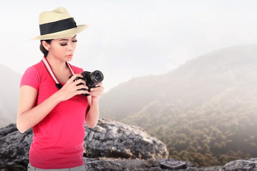 A tourist taking image with camera on mountain landscape